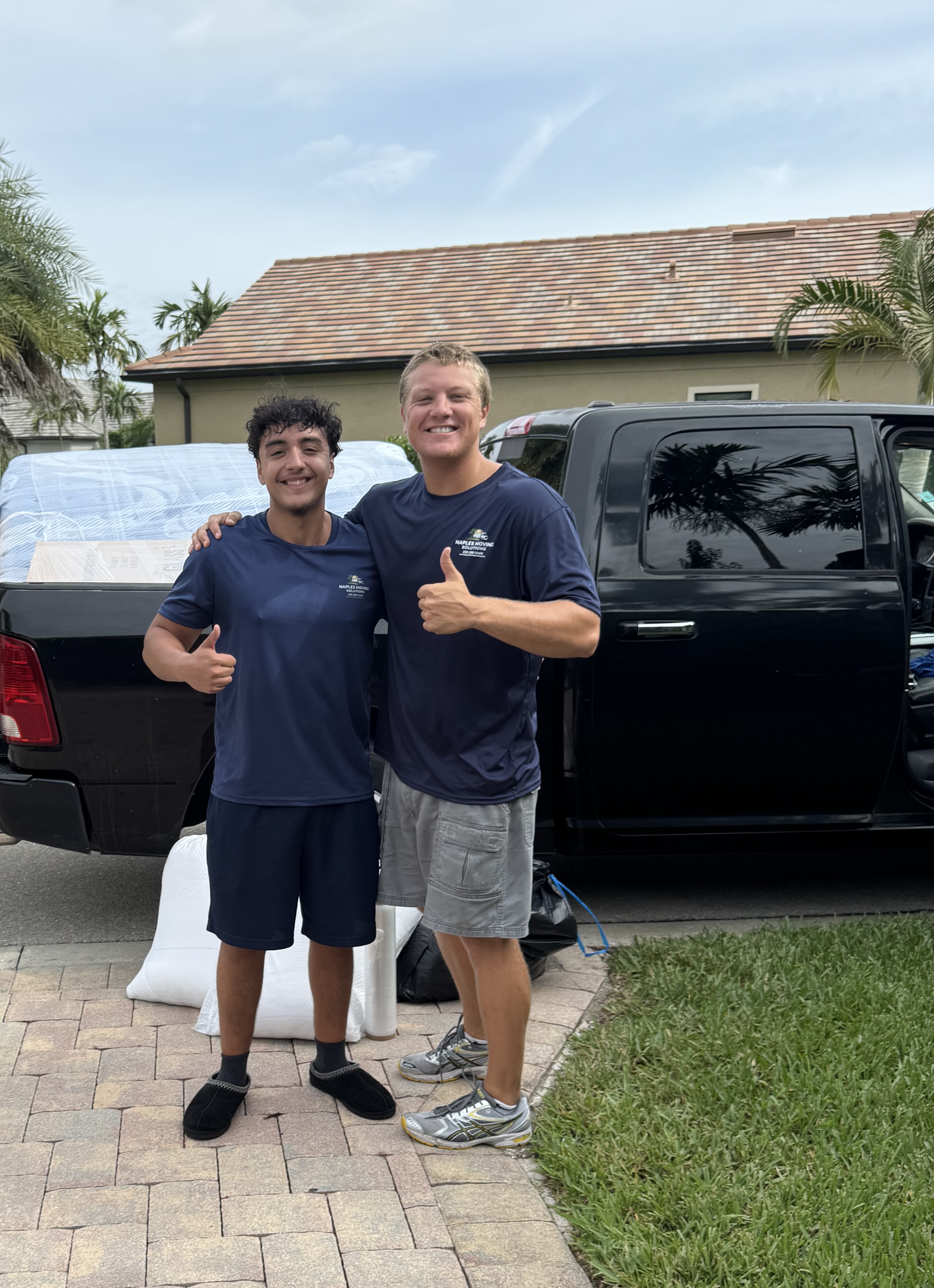 Naples Moving Solutions professional movers giving thumbs up after a successful move in Naples FL